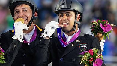 Indias bronze medalist Anush Agarwalla (Etro) stands at the podium with Malaysia's gold medalist Bin Mahamad Fathil Mohd Qabil Ambak after the Equestrian Dressage Individual Final event at the 19th Asian Games, in Hangzhou, China, Thursday, Sept. 28, 2023. (PTI Photo/Gurinder Osan)