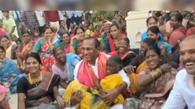 Minister Malla Reddy lifted an elderly woman in his arms.