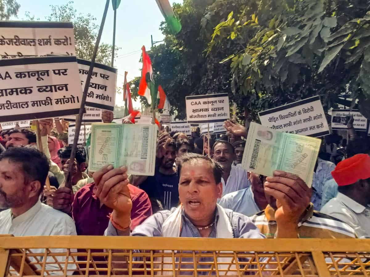 Hindu and Sikh refugees raise slogans during a protest against Delhi Chief Minister Arvind Kejriwal