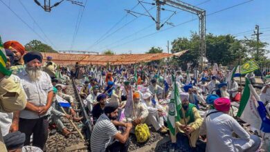 Farmers sit on railway tracks during a protest at the Shambhu border, in Patiala district,