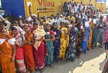 Voters wait in a queue to cast votes at a polling station during the first phase of the Bihar Assembly elections at Bakhtiarpur in Patna on Thursday. (PTI Photo)