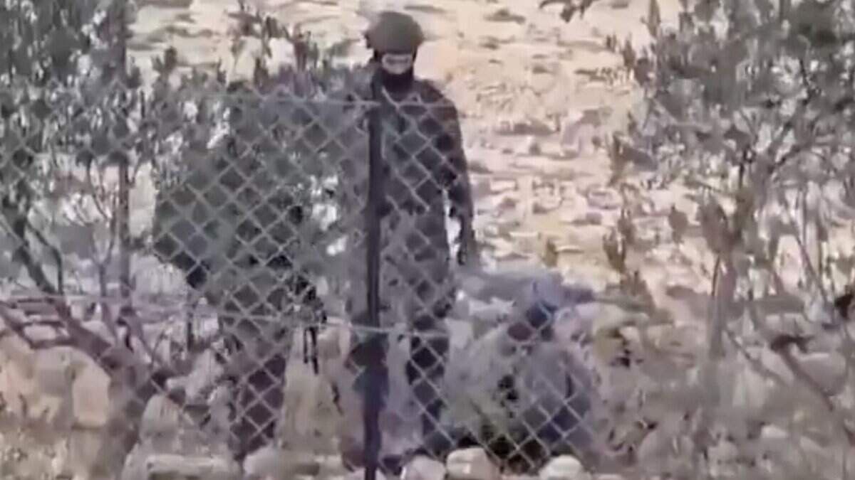 Israeli soldiers assault a Palestinian man