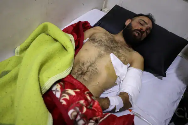 Injured man receives treatment after clashes in Latakia