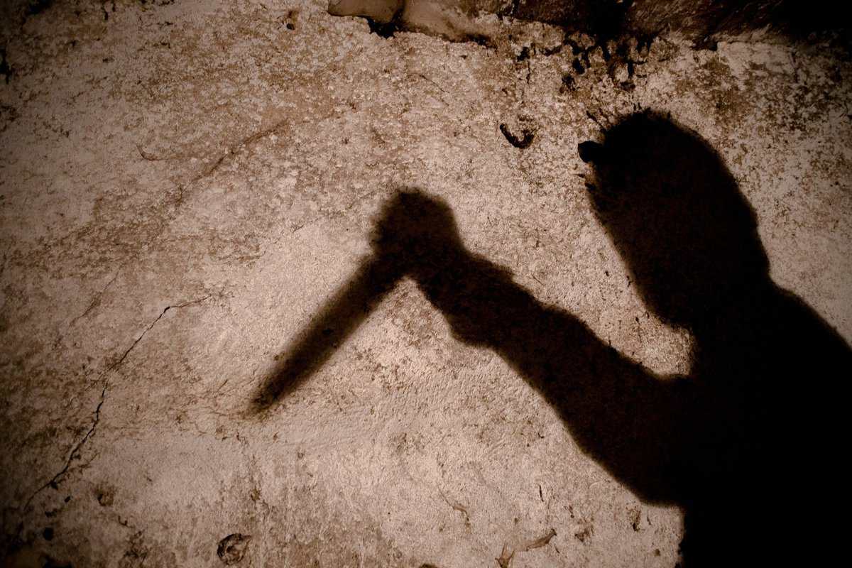 shadow of a man with a big knife