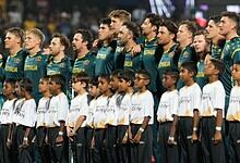 Australian cricket team standing together during a game.