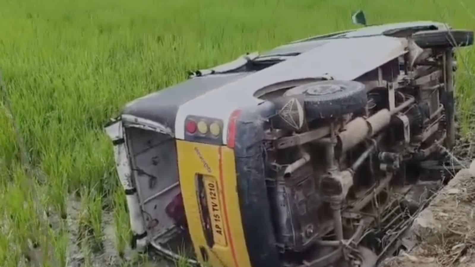 Upside-down bus carrying school students after accident in Telangana, with visible damage and overturned.