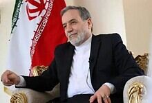 Iranian Foreign Minister during nuclear talks with US, seated in a formal setting.