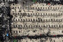 Aerial view of mourners at a cemetery in Iran during a memorial event.