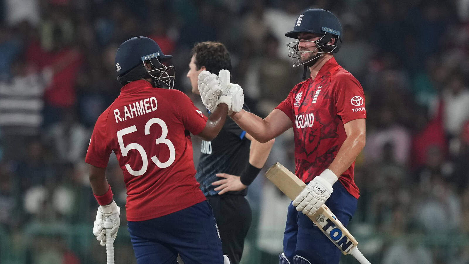 England cricketers R. Ahmed and Rehan celebrate a key wicket in T20 World Cup.