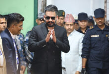 Balendra Shah, foreground, former mayor of Kathmandu Metropolitan City and prime ministerial candidate of the Rastriya Swatantra Party, arrives to receive his victory certificate