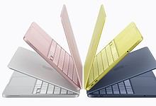 Colourful Apple MacBook laptops displayed in pink, yellow, white, and navy blue, highlighting affordabili.