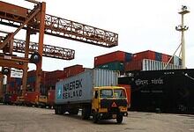Ship and cargo containers at the port in Kerala, India.
