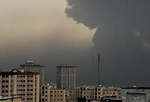 Indian nationals in Iran as dark storm clouds gather over city skyline.