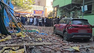 Scaffolding collapse incident in Tolichowki with rescue teams and onlookers at the scene.