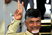 Andhra Pradesh Chief Minister holding up a peace sign at an award ceremony.