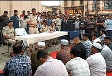 Police officials addressing shopkeepers during a raid on illegal 'hidden tax' practices.