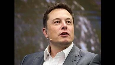 Elon Musk speaking at a SpaceX event, focusing on space exploration and innovation.