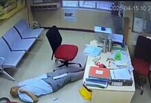 Man experiencing a heart attack collapses at a bank in Hyderabad, lying on the floor as staff and custome.