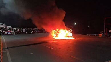 Explosion on the road with fire and smoke at night.