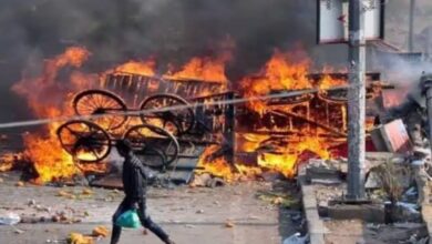 A man walks past a burning structure during the 2020 Delhi riots (File Photo)