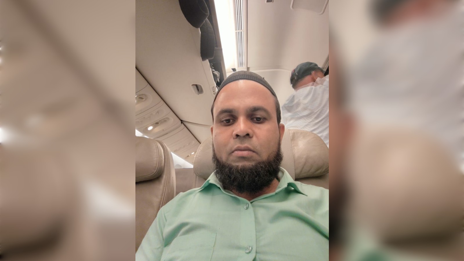 Faiyaz Alam seated inside an aircraft cabin.