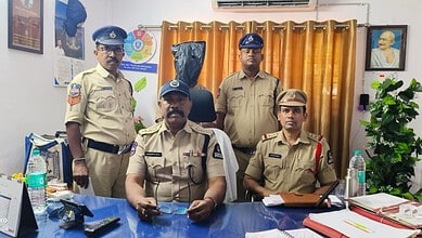 Police officers in uniform posing in an office setting with curtains and framed photographs.