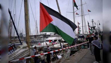Global Sumud Flotilla boats docked in Barcelona with Palestinian flags ahead of Gaza-bound mission.