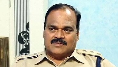 A police officer in uniform speaking during an interview or press conference.