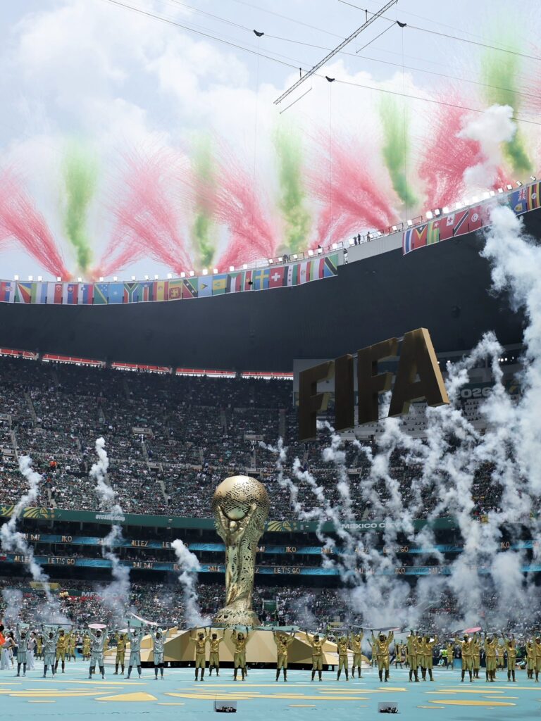 Spectacular FIFA World Cup final with fireworks, large crowd, and iconic trophy display in stadium.