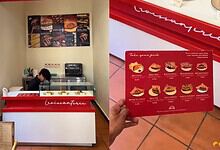 A. Freshly baked pastries and desserts displayed at a bakery counter with a menu board in the background.