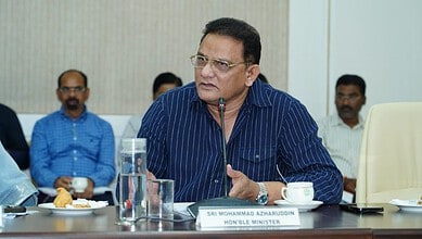 Honourable Minister Md. Azamuddin speaking at a formal meeting with colleagues.