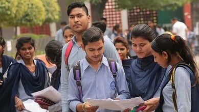 Students in school uniforms reading and discussing exam results outdoors.