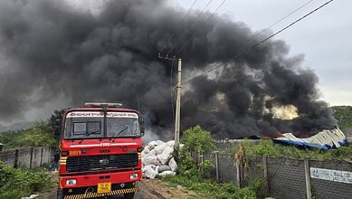 Fire at a plastic unit in Hyderabad with thick black smoke billowing into the sky.