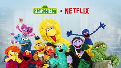 Sesame Street characters with Netflix logo, celebrating new film rights acquisition.