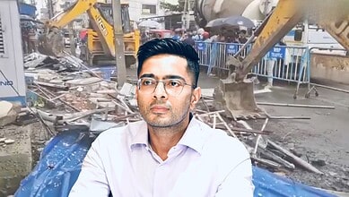 Man in white shirt and glasses at demolition site with bulldozers in background.