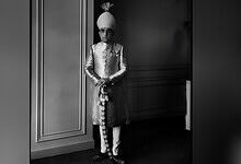 Azam Jah in traditional attire with turban, standing indoors in black and white.