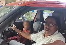 Man driving car with young girl in passenger seat, blurred face, in Hyderabad.