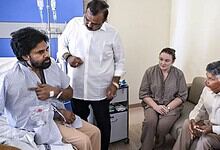 Pawan Kalyan in hospital with medical team and visitors after shoulder surgery.