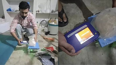 Person weighing a substance with a digital scale in a room, close-up of the scale display.