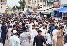 Large crowd protesting at Charminar over NEET paper leak in Hyderabad.