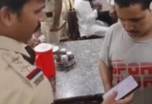 Chaderghat police officials check phones in a cafe in Hyderabad.