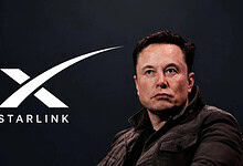 Elon Musk standing next to Starlink logo on a dark background.