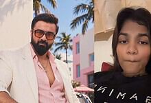 Ajaz Khan and influencer taking a selfie, outdoor setting with palm trees.