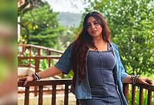 Arshi Khan posing outdoors with greenery in the background, wearing a denim jacket and top.