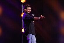 Comedian Munawar Faruqui performing on stage during a fan event in Dubai.