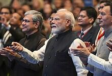 Prime Minister Narendra Modi at a formal event with officials and delegates.