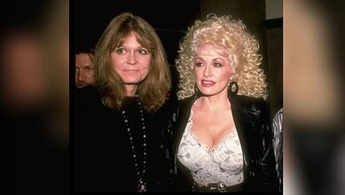 Two women with distinct hairstyles and fashion styles at a social event.