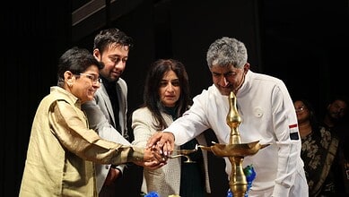 Kiran Bedi lighting a traditional lamp at an event promoting self-discipline and positive thinking.
