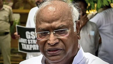 Senior man with glasses and white shirt at a protest or gathering.