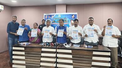 Group of officials holding certificates at a formal event in Telangana.